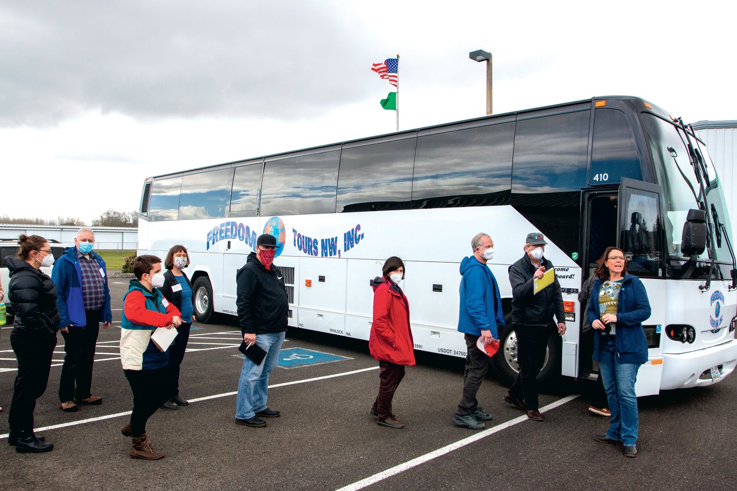 The tour group boards the bus after completing a stop at the Chehalis-Centralia Airport.